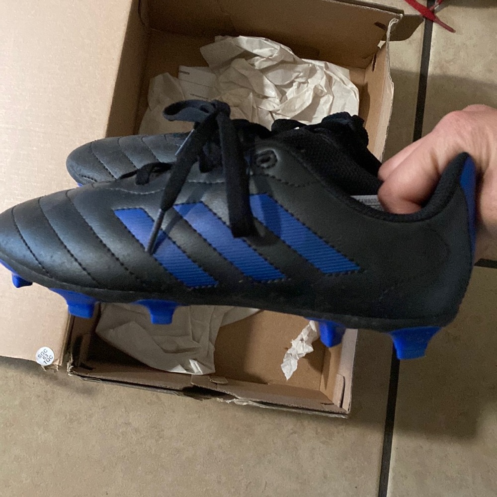 Blue and black boy soccer shoes
